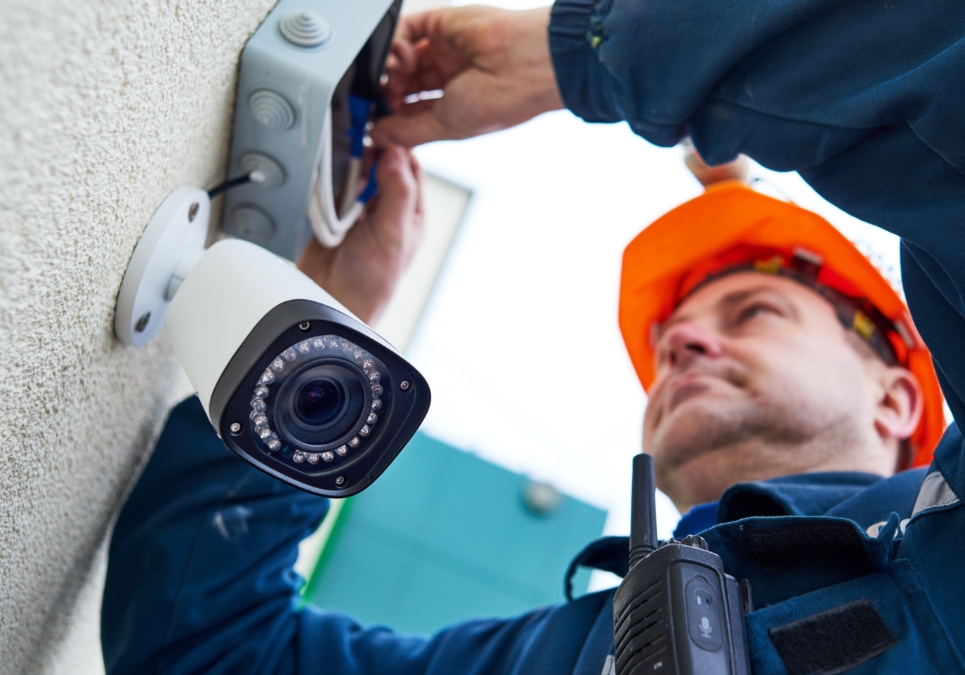 A specialist installing a security camera